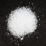 pile crystalline citric acid close up black